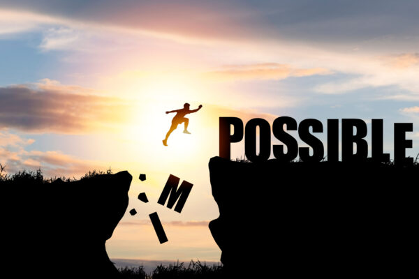 Mindset,Concept,,silhouette,Man,Jumping,Over,Impossible,And,Possible,Wording