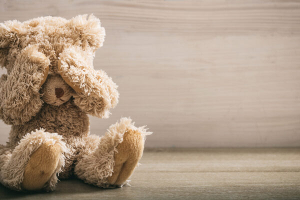 Child,Abuse,Concept.,Teddy,Bear,Covering,Eyes,In,An,Empty